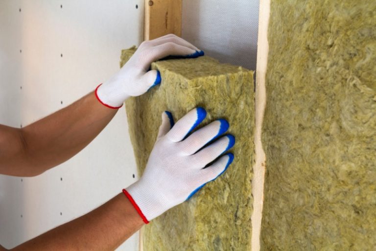 A hand installing own insulation