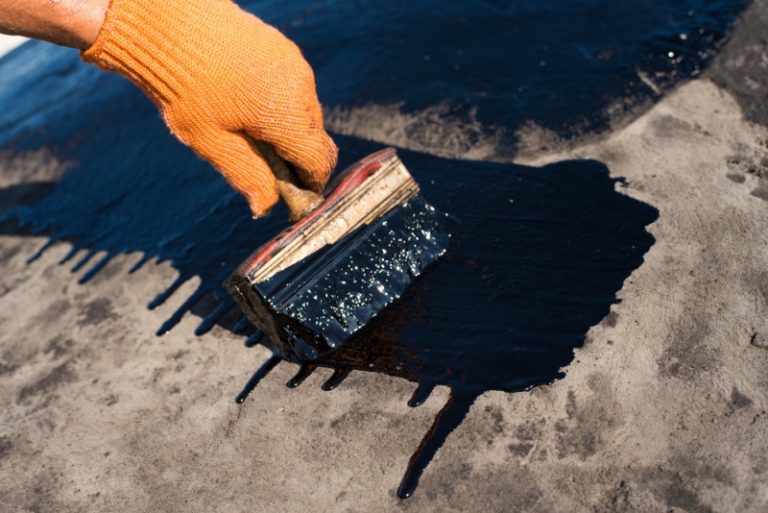 A contractor using rubber roof for a home