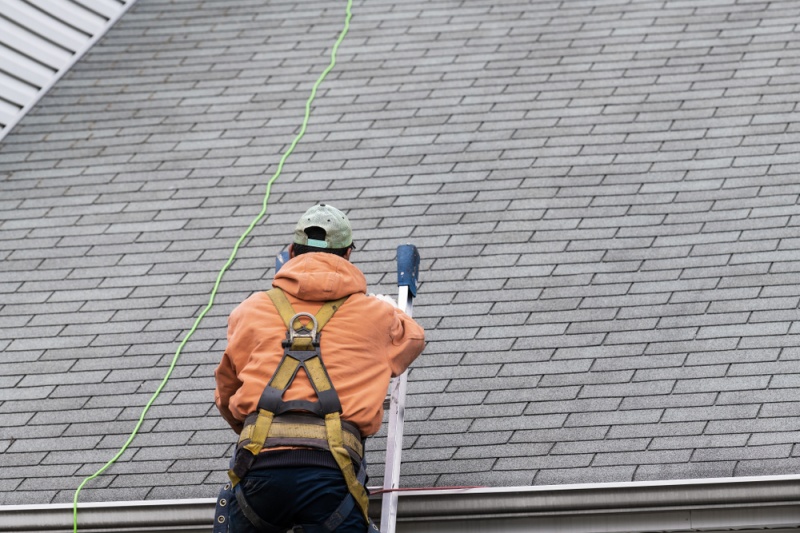 Man Inspecting the Roof